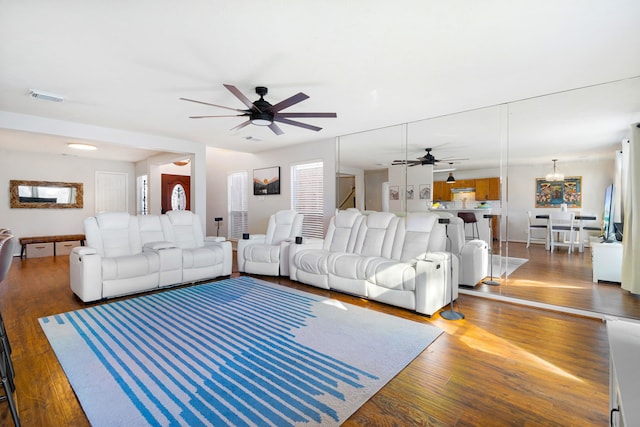 living room with dark hardwood / wood-style floors and ceiling fan