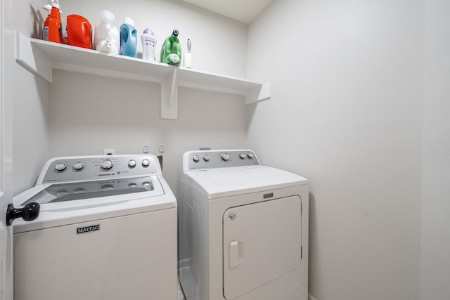 washroom featuring washer and clothes dryer