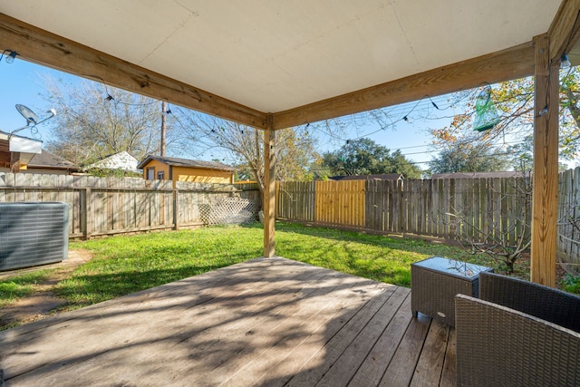 wooden terrace with central AC, a yard, and a fenced backyard