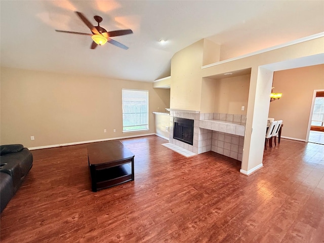 unfurnished living room with a fireplace, ceiling fan, hardwood / wood-style floors, and vaulted ceiling