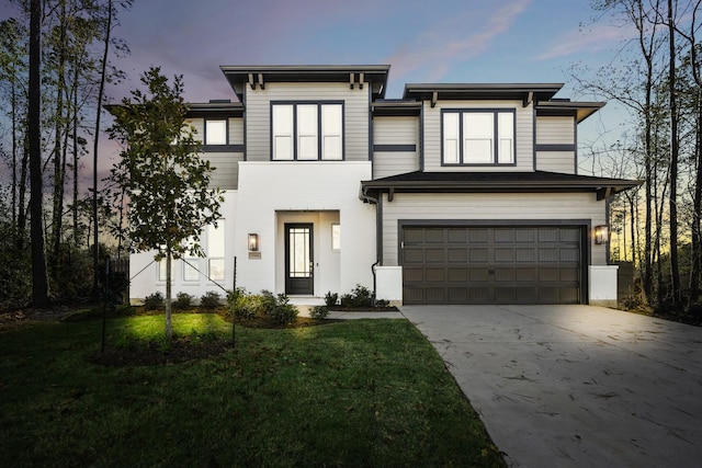 view of front of property featuring a yard and a garage