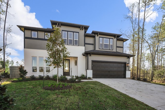 view of front of property with a garage and a front lawn