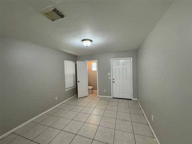 empty room with light tile patterned floors