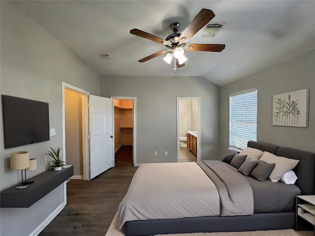 bedroom with a spacious closet, dark hardwood / wood-style floors, ensuite bathroom, a closet, and ceiling fan