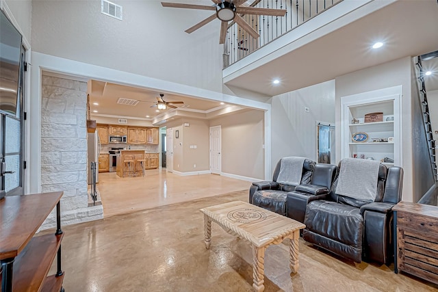 living room with ceiling fan and built in features