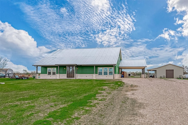 view of front facade with an outbuilding, a garage, and a front yard