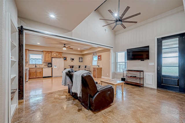 living room featuring ceiling fan and sink