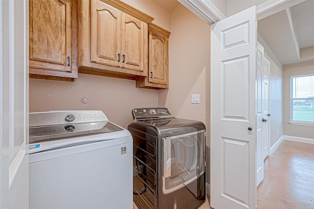 laundry area featuring cabinets and independent washer and dryer