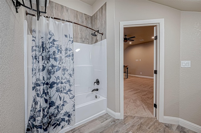 bathroom featuring shower / bathtub combination with curtain and ceiling fan