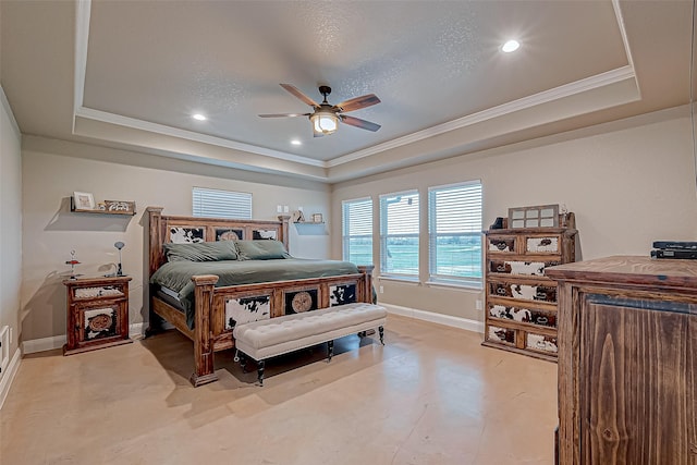 bedroom with ceiling fan, crown molding, and a tray ceiling