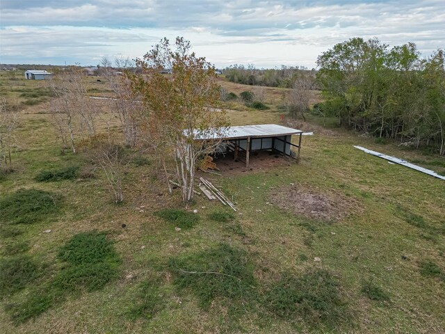 view of yard with a rural view and an outdoor structure