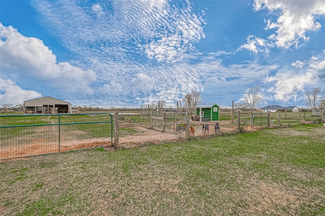 view of yard featuring a rural view and an outdoor structure