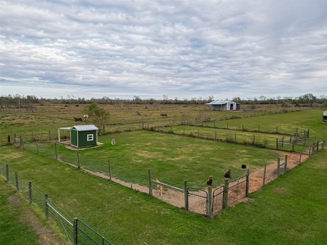 view of yard featuring an outbuilding and a rural view