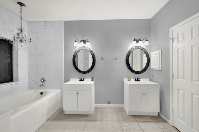 bathroom with a bathtub, vanity, a chandelier, and tile patterned flooring