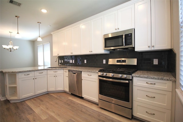 kitchen with white cabinetry, sink, light wood-type flooring, and appliances with stainless steel finishes