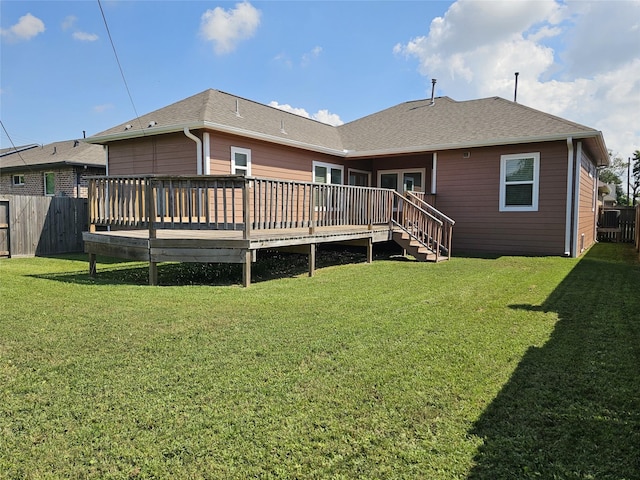 rear view of property with a lawn and a wooden deck