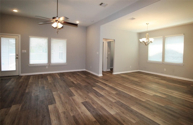 unfurnished living room with ceiling fan with notable chandelier and dark wood-type flooring