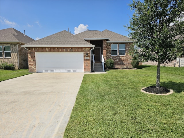 view of front of home featuring a garage and a front lawn