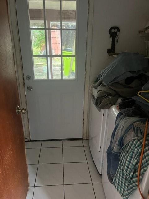 laundry room with light tile patterned floors and washer and dryer