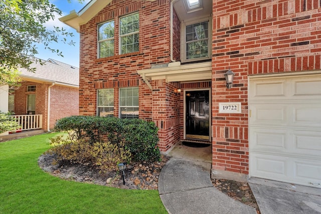 property entrance with a yard and a garage