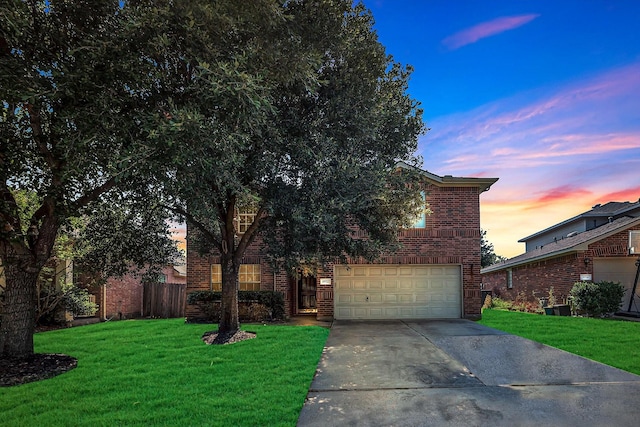 view of front of house featuring a garage and a yard