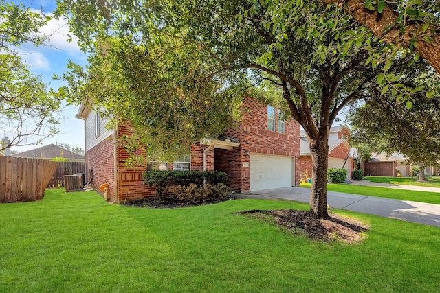 view of front of home featuring a garage, a front yard, and central air condition unit