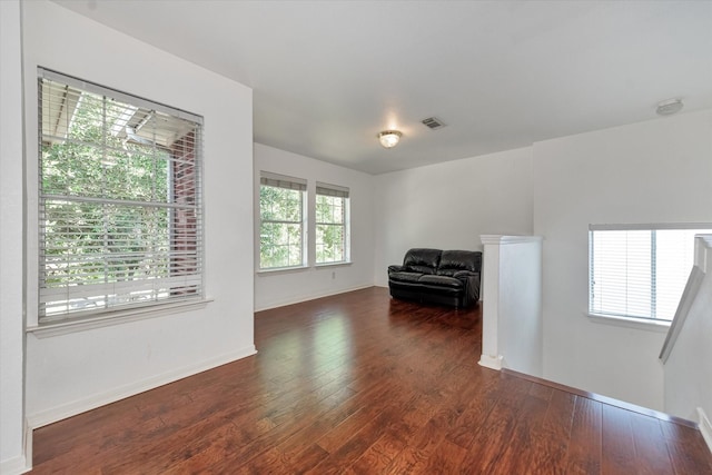 unfurnished room with dark hardwood / wood-style flooring