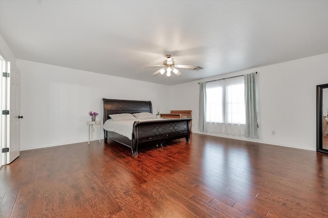 bedroom with dark wood-type flooring and ceiling fan