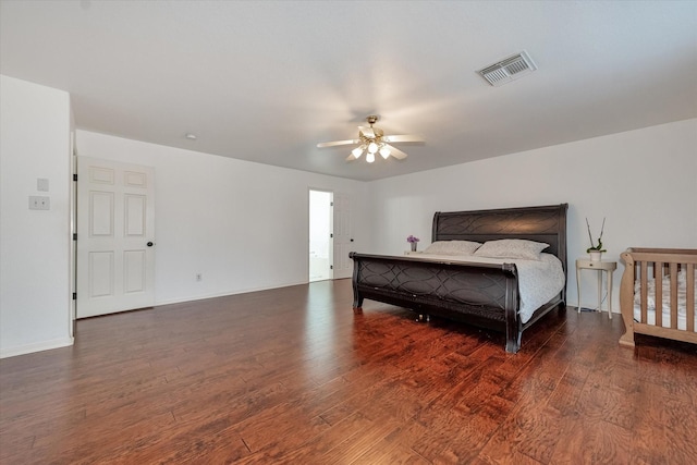 bedroom with dark wood-type flooring and ceiling fan