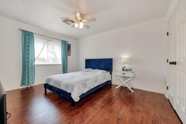 bedroom with ceiling fan, dark hardwood / wood-style flooring, and a closet