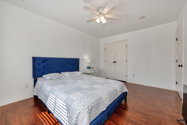 bedroom featuring ceiling fan, dark hardwood / wood-style flooring, and a closet