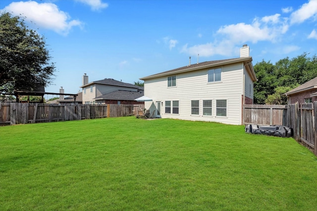 back of house featuring a yard