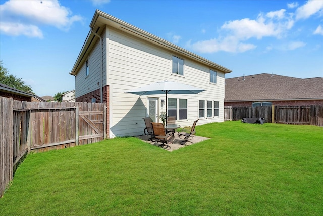 back of house featuring a patio and a lawn