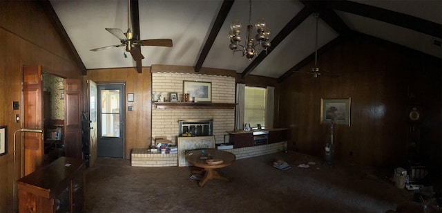 living room featuring wood walls, ceiling fan with notable chandelier, carpet flooring, vaulted ceiling with beams, and a fireplace