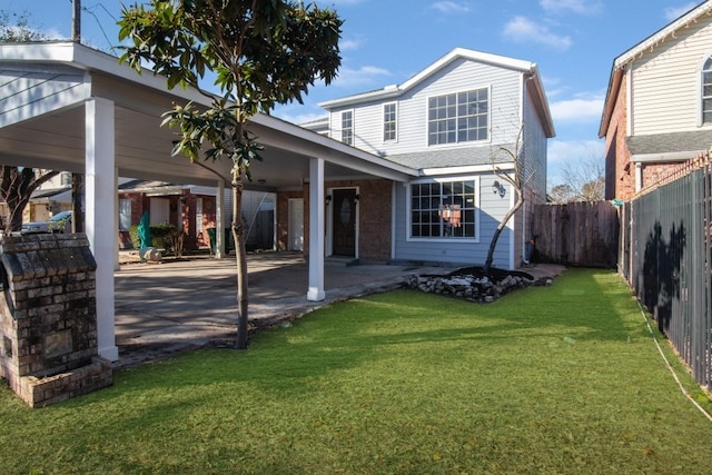 rear view of property featuring a lawn and a patio