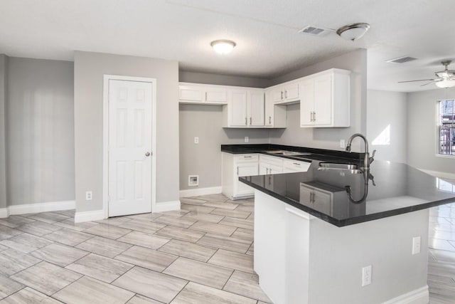 kitchen with white cabinetry, ceiling fan, kitchen peninsula, and sink