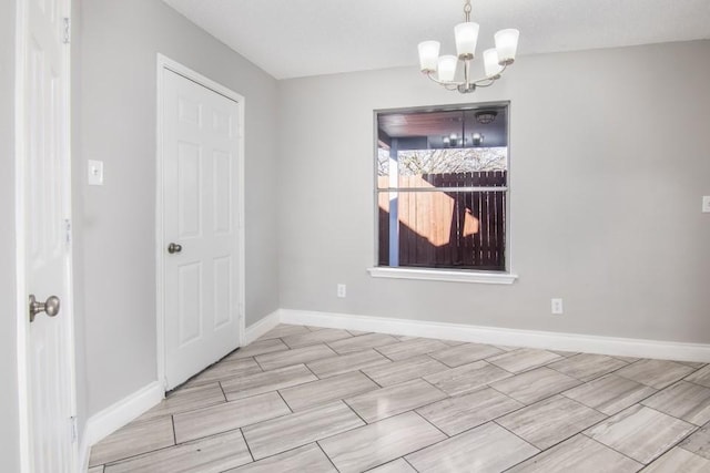 empty room featuring an inviting chandelier