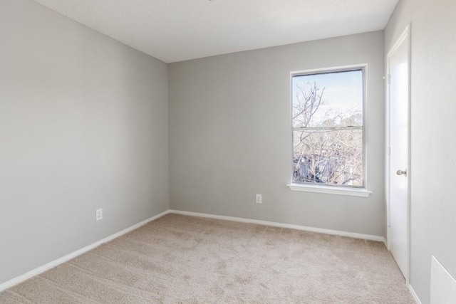 unfurnished room with light colored carpet