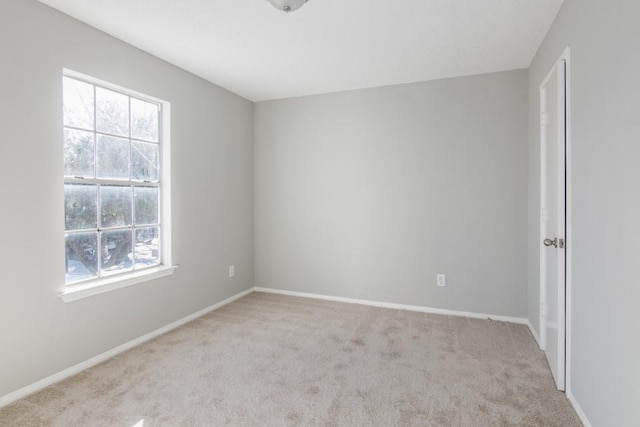 spare room featuring light colored carpet