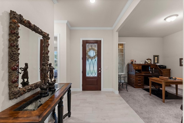 entrance foyer with light colored carpet and ornamental molding