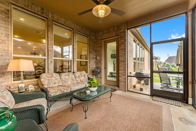 sunroom featuring ceiling fan