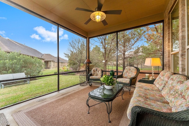 sunroom / solarium featuring ceiling fan