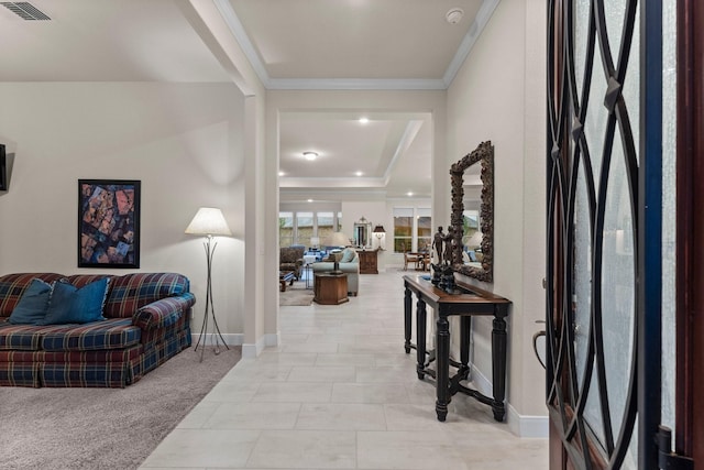 foyer featuring light colored carpet and ornamental molding