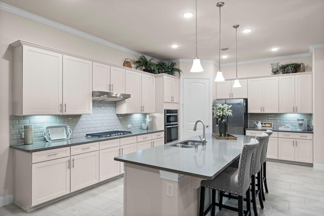 kitchen with sink, white cabinets, hanging light fixtures, and appliances with stainless steel finishes