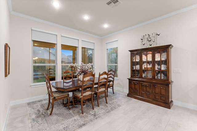 dining space featuring crown molding