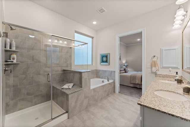 bathroom with vanity and independent shower and bath