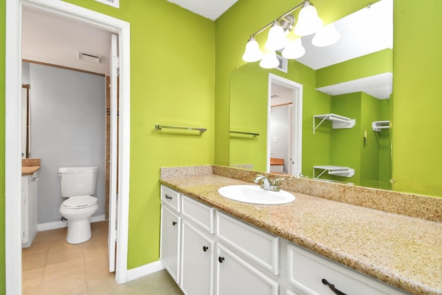 bathroom featuring tile patterned flooring, vanity, and toilet