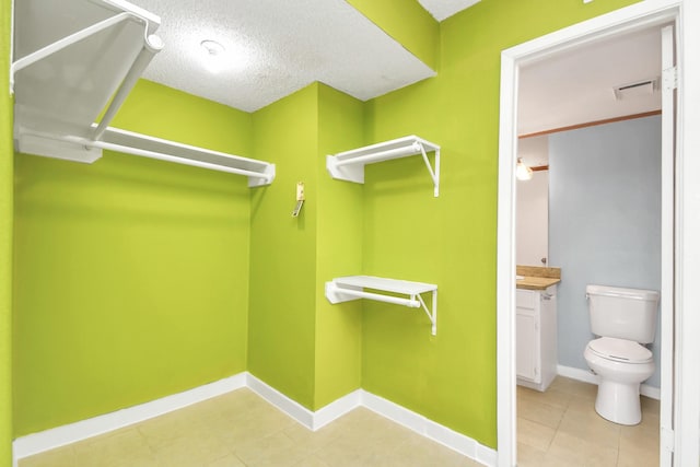 walk in closet featuring tile patterned floors