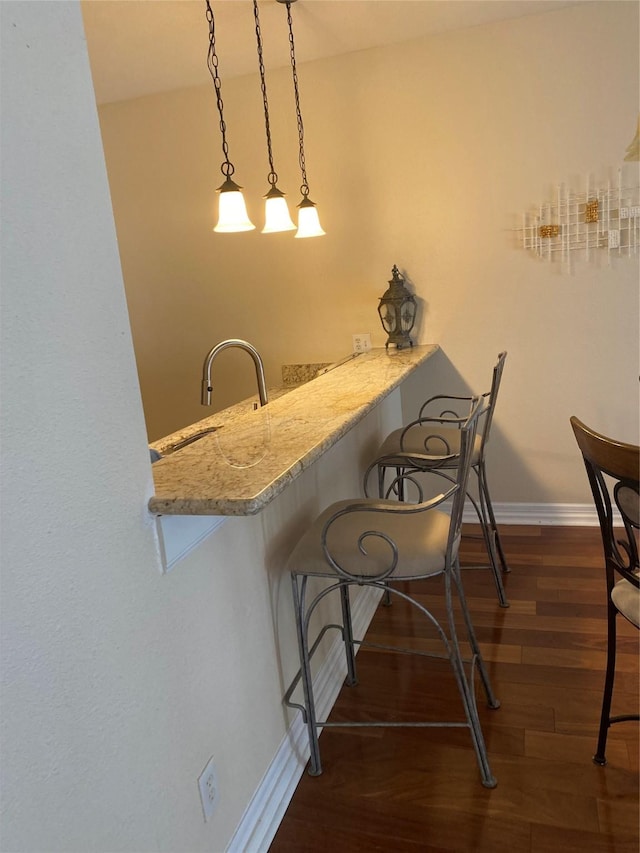 dining area with dark hardwood / wood-style floors and sink