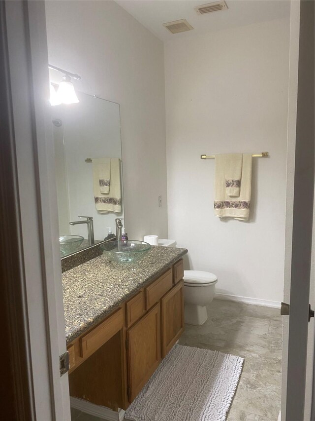 bathroom featuring toilet and vanity